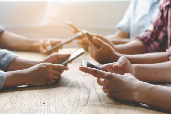 Teen hands holding cellphones