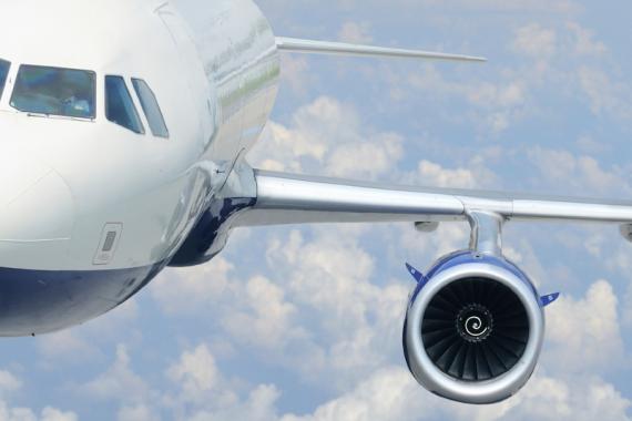The left side of an Airbus A330 flying through a cloudy sky
