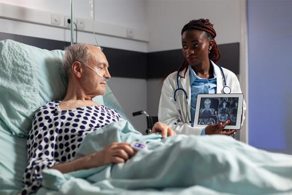 Patient in medical bed with Doctor visiting