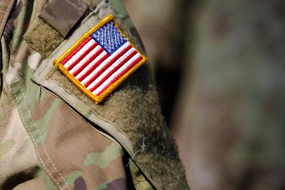 A close-up view of an American flag patch on a military uniform